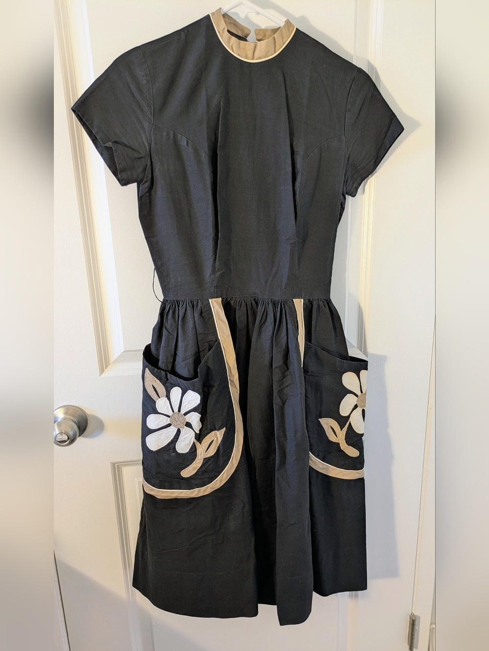 Vintage 1950s–60s black dress with beige trim & machine-sewn floral appliqué
